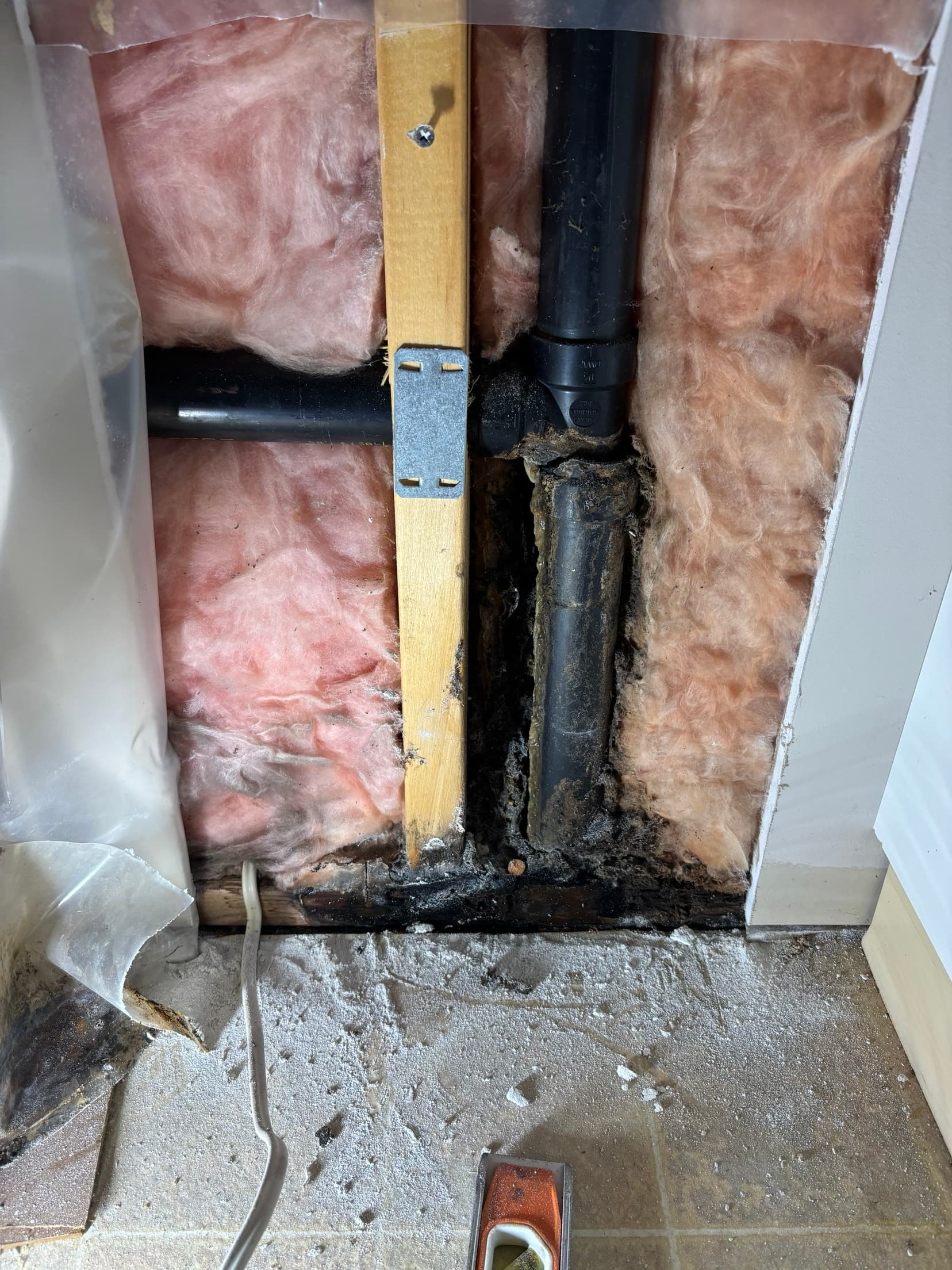 Corroded in-wall drain stack before replacement